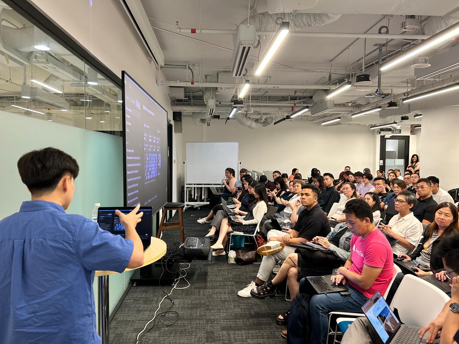 Varick Lim presenting an AI workflow workshop to an audience